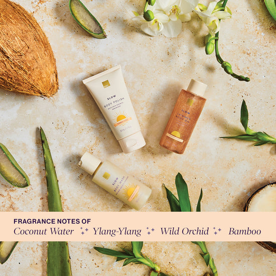 Summer Oasis collection products over a stone surface. Fragrance notes of coconut water, ylang-ylang, wild orchid and bamboo.