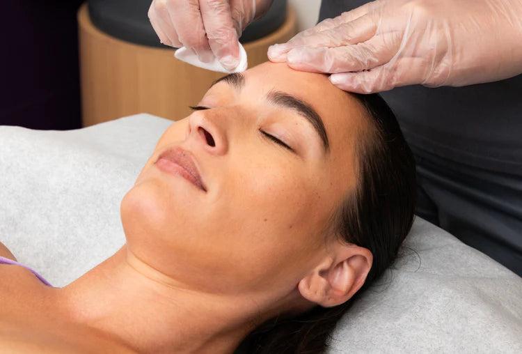 Woman getting her face prepped for eyebrow tint