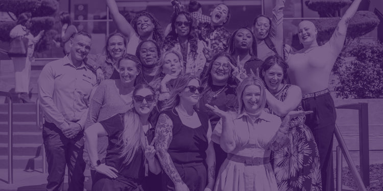 Group of people posing together outdoors with a blurred purple filter