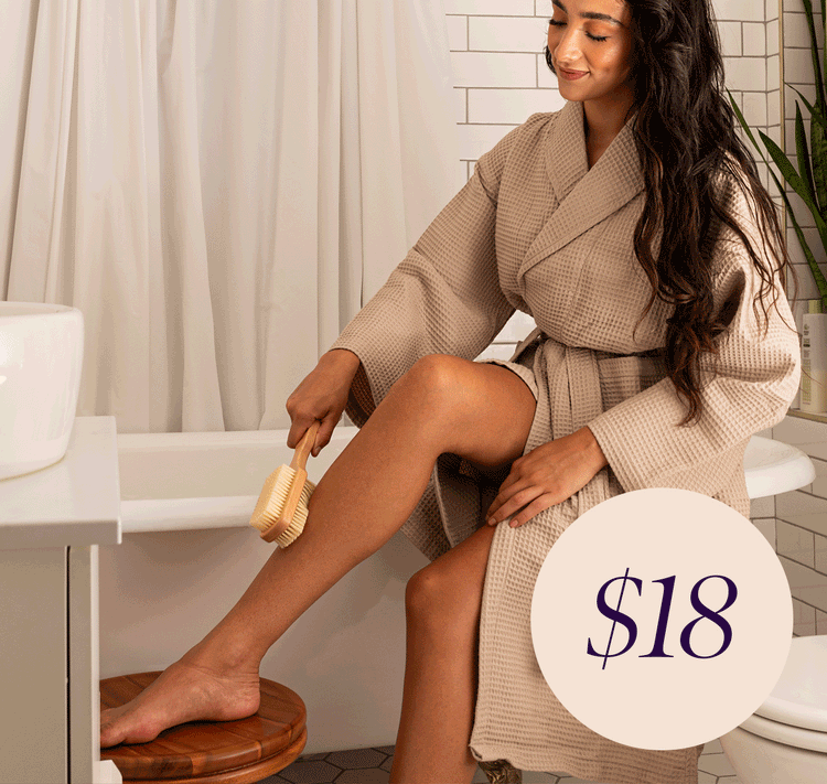 Women exfoliating their skin in the bathroom with the EWC Dual-sided Dry Brush. Only $18.