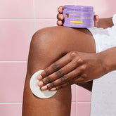 A woman applying the Brightening Ingrown Hair wipe to her waxed leg.
