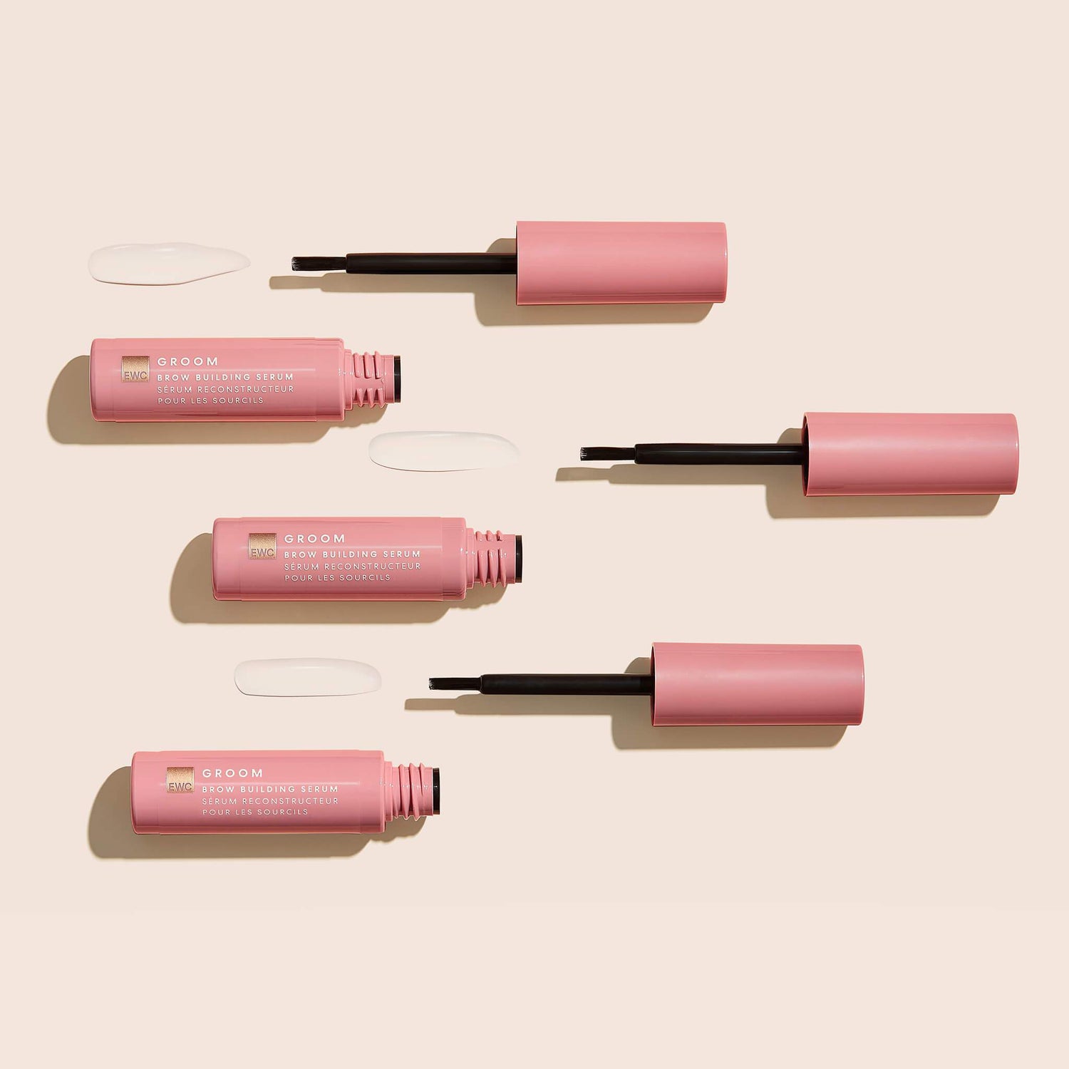 3 open bottles of Brow Building Serum on a light background.