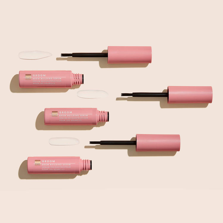 3 open bottles of Brow Building Serum on a light background.