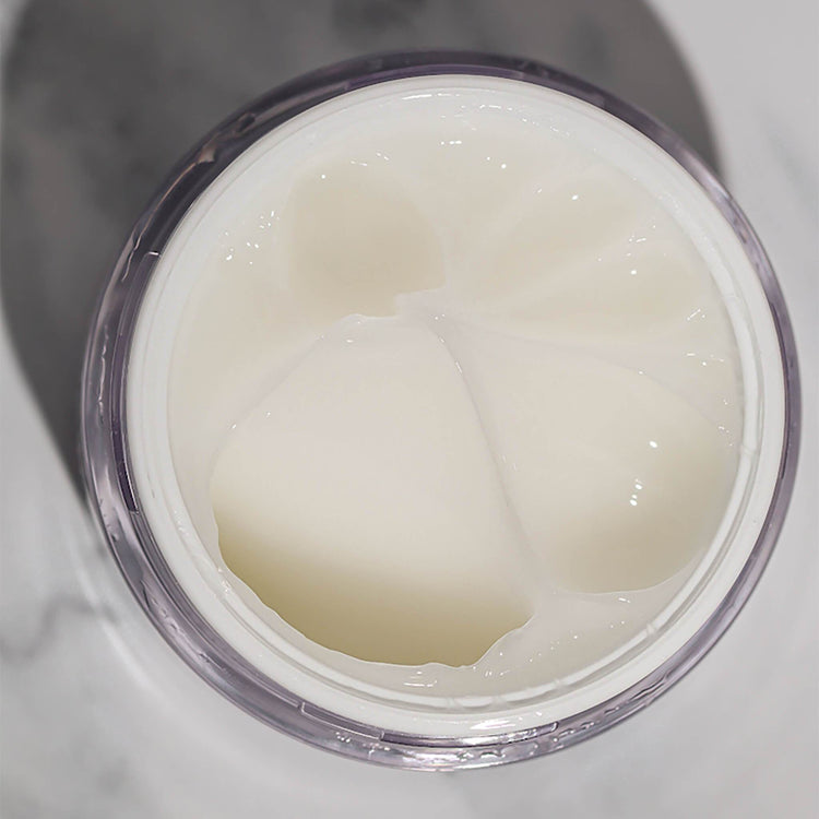 Top view of an open container of EWC TREAT Face & Body Exfoliating Gel.
