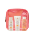 4 Piece Summer Oasis Travel Kit, EWC SLOW travel size products (body wash, body polish and shimmer body oil) arranged in front of a coral pouch.