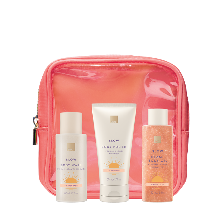 4 Piece Summer Oasis Travel Kit, EWC SLOW travel size products (body wash, body polish and shimmer body oil) arranged in front of a coral pouch.
